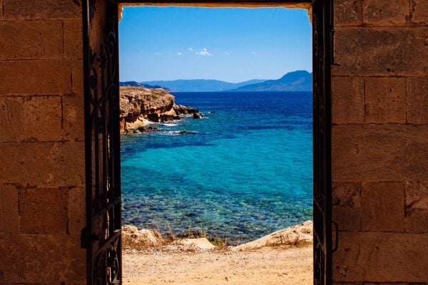 may-2016-aegina-greece-ancient-door-with-a-view-of-the-mediterranean-sea_t20_g8QQxd